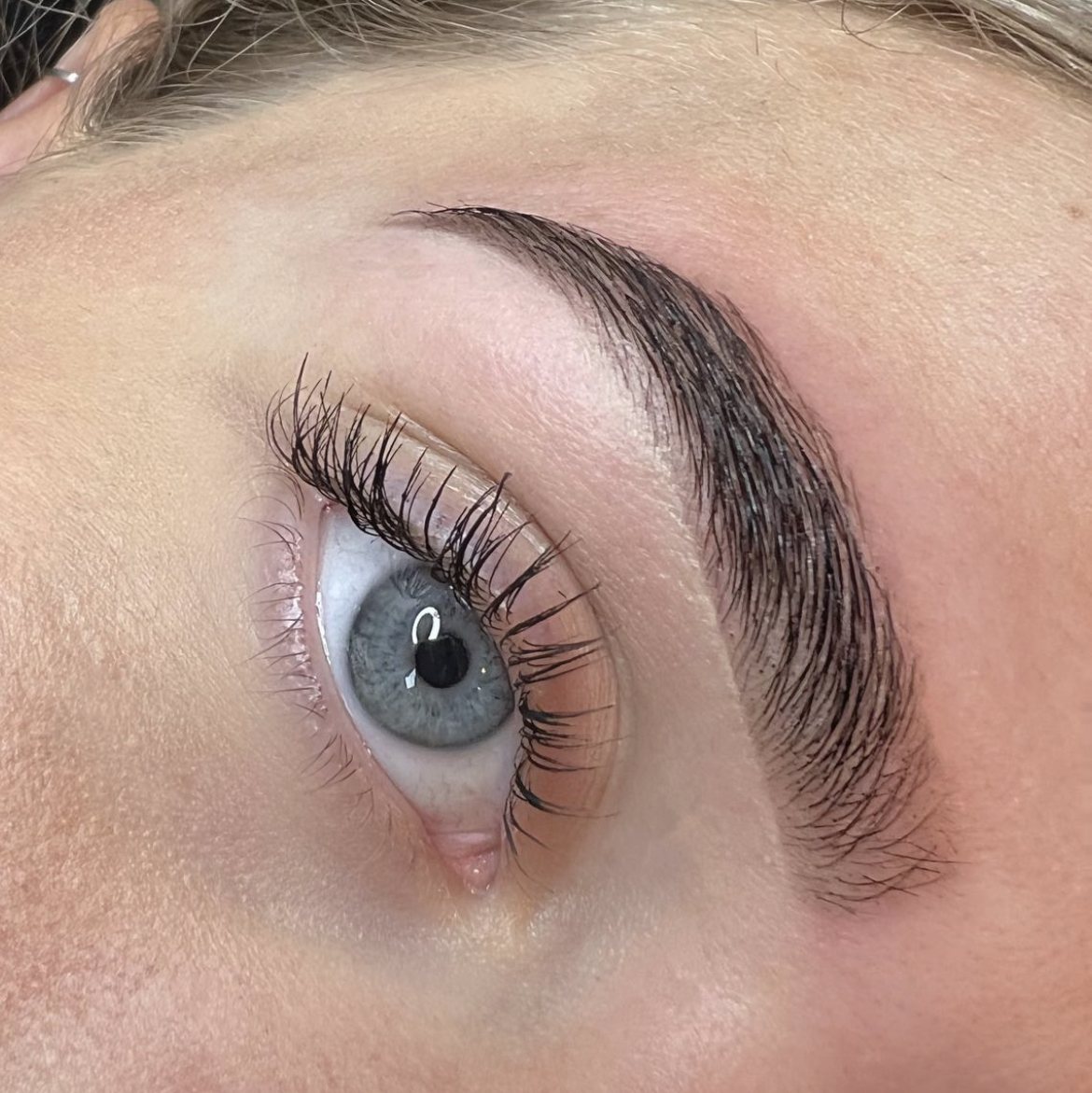 Wenkbrauw en wimpers van dichtbij, blauw oog